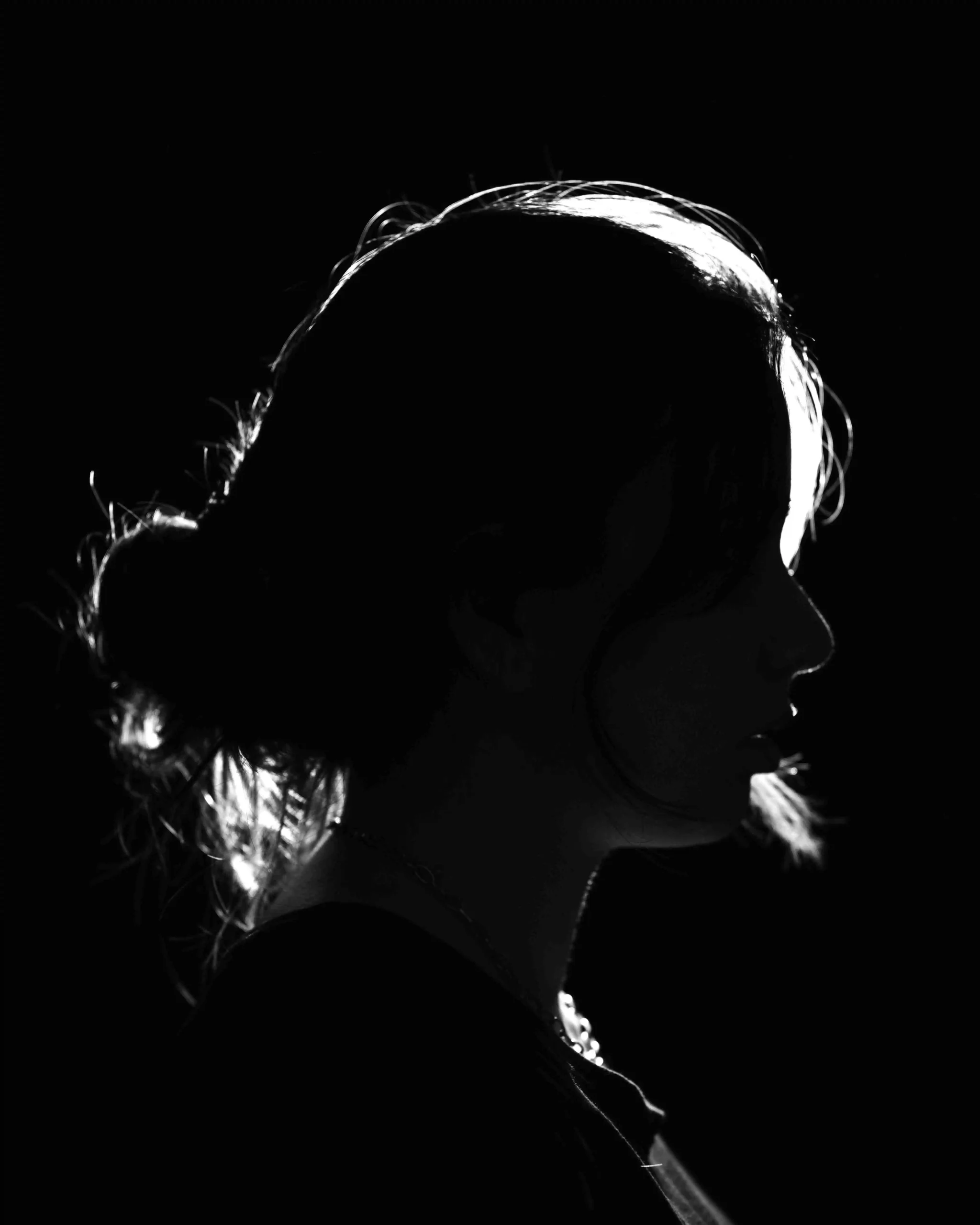 Dramatic black and white silhouette portrait with light rim for editorial