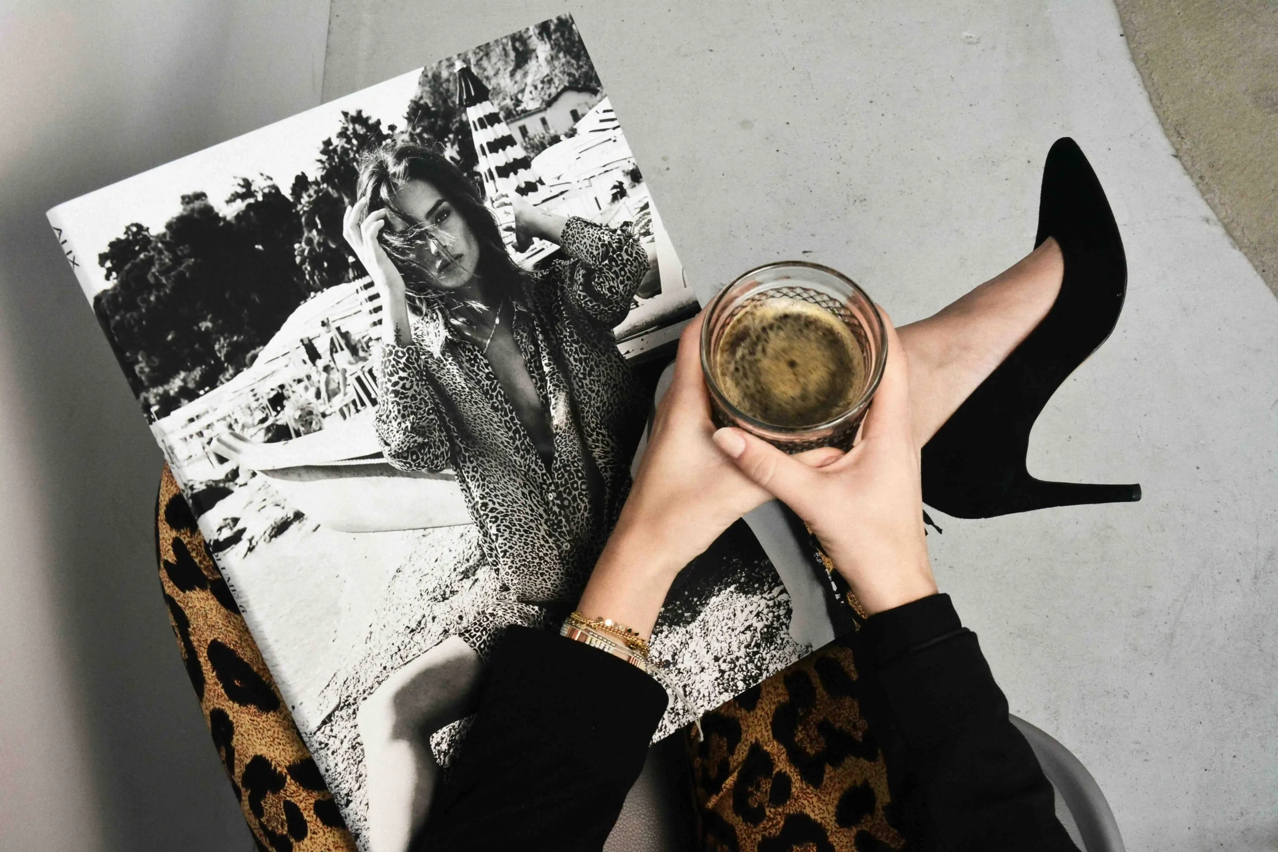 Woman reading fashion magazine with coffee and heels for lifestyle editorial